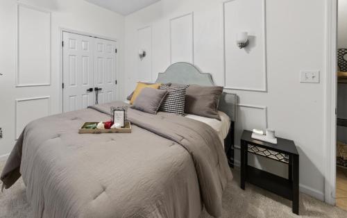 a bedroom with a bed with a tray of fruit on it at The Executive Suite in McDonough