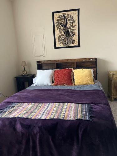 a bedroom with a bed with colorful pillows at Five Oaks Retreat in Salem