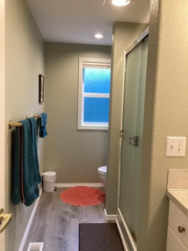 a bathroom with a toilet and a window at Five Oaks Retreat in Salem