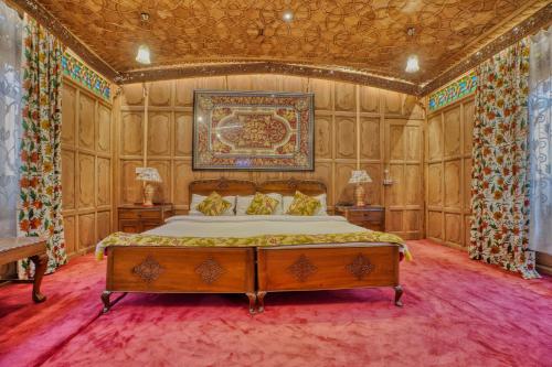 a bedroom with a bed and a painting on the wall at Alexandra Houseboats in Srinagar