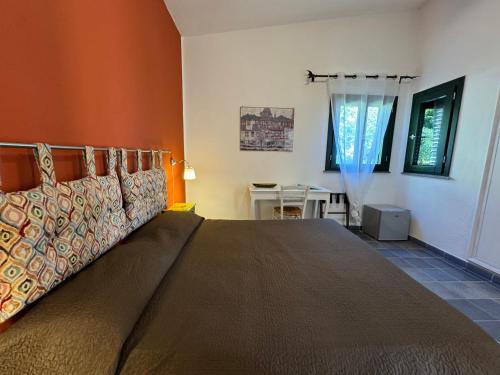 a bedroom with a bed in a room with a table at Baglio La Luna - B&B in San Vito lo Capo