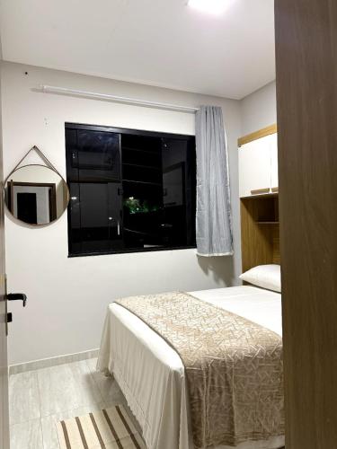 a bedroom with a bed and a window at Pousada & Flat Brandão - Canindé de São Francisco, SE in Canindé de São Francisco