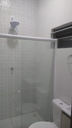 a bathroom with a glass shower with a toilet at Pousada & Flat Brandão - Canindé de São Francisco, SE in Canindé de São Francisco