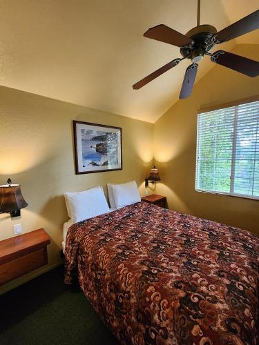 a bedroom with a bed with a ceiling fan at Lighthouse Pointe Resort in Point Arena