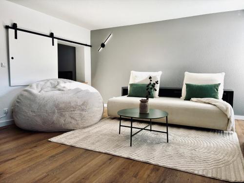 a living room with a couch and a table at LYMA Suites - Apartment G2 in Immenstadt im Allgäu