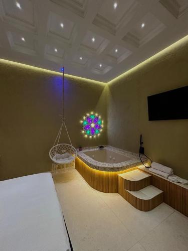 a large bathroom with a tub and a tv at Erbanova al Borgo Suite in Taranto
