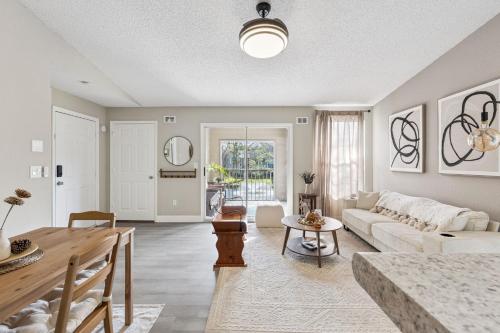 a living room with a couch and a table at Quiet Gated Condo Near Universal with Pool and View in Orlando