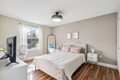 a bedroom with a bed and a television in it at Quiet Gated Condo Near Universal with Pool and View in Orlando
