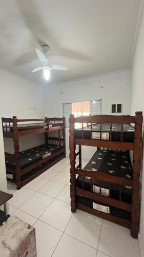 a room with three wooden shelves in a room at Casa de Praia com piscina in Mongaguá