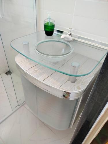 a glass counter in a bathroom with a sink at Ap 2quartos atras do shopping in Votorantim