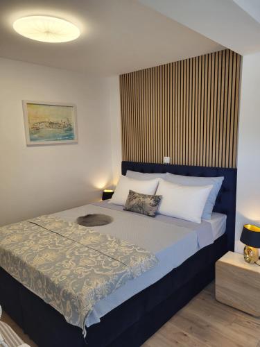 a bedroom with a large bed with two pillows at Apartments Aldo in Cavtat