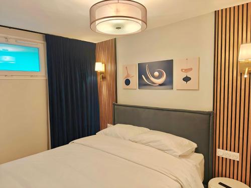 a bedroom with a bed and a projection screen at SCI Gomis Invest in Issy-les-Moulineaux