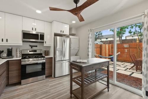 a kitchen with stainless steel appliances and a patio at Contemporary Couples Getaway Near Austin Favorites - Loft 21 in Austin