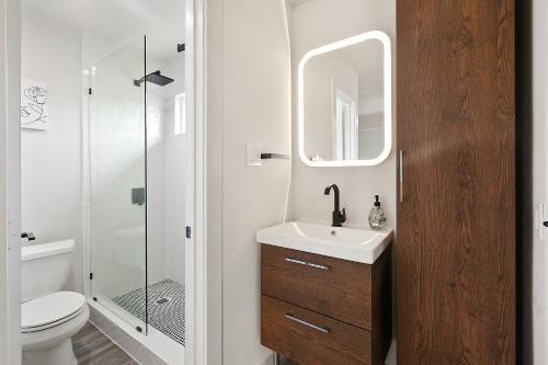a bathroom with a toilet and a sink and a shower at Contemporary Couples Getaway Near Austin Favorites - Loft 21 in Austin