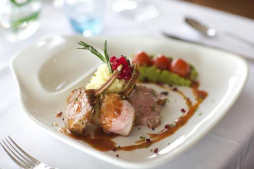 a plate of food with meat and vegetables on a table at Waterfront Hotel Dungloe in Dungloe