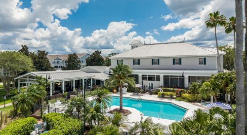 an aerial view of a house with a pool and palm trees at Quiet Gated Condo Near Universal with Pool and View in Orlando