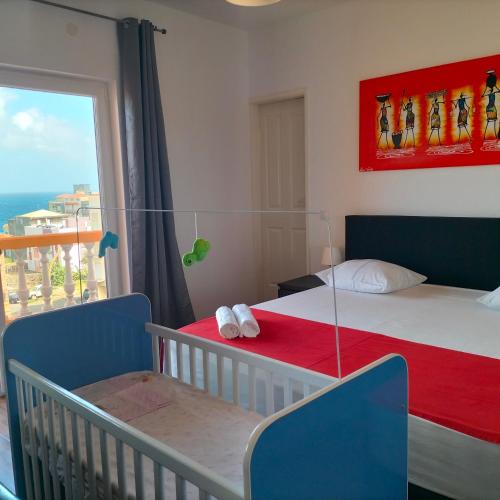 a bedroom with a bed and a large window at Hotel Miranda & Miranda in Ponta do Sol