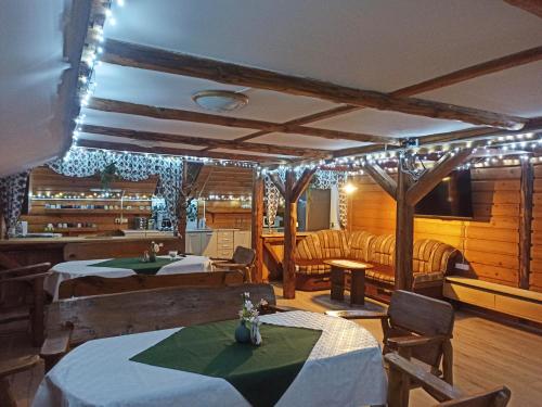 a dining room with tables and chairs and lights at Agroturystyka Pod Małą Górą in Łopuszna