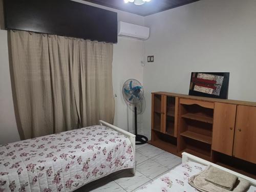 a bedroom with a bed and a fan at Alojamiento Fiara in Chajarí