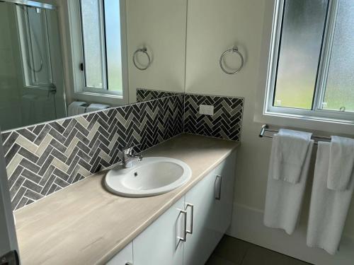 a bathroom with a sink and a counter with towels at Victor Harbor Holiday Park in Victor Harbor