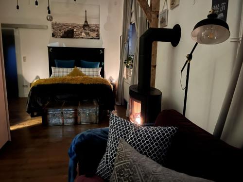 a bedroom with a bed and a fireplace in it at Boutique Apartment Benz 2 in Bergisch Gladbach