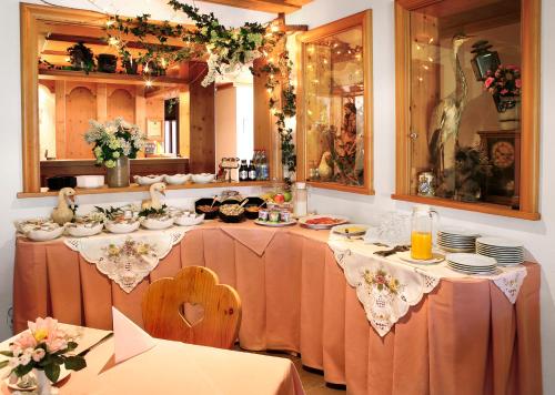 a kitchen with a table with dishes on it at Hotel Hubertus in Kissing