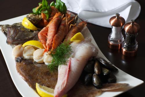 a plate of fish with seafood and vegetables on a table at Waterfront Hotel Dungloe in Dungloe
