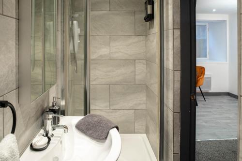 a bathroom with a sink and a shower at Studio Close To Alhambra And Bradford Live Walk To Stations in Bradford