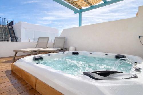 a hot tub on the roof of a building at Elegant 4BR Sliema House with Rooftop Jacuzzi in Sliema