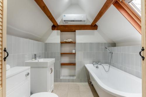 a bathroom with a toilet and a sink and a bath tub at 2 Bed in Latton oc-c34099 in Clapton