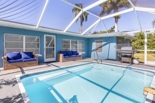 a swimming pool in a house with a glass roof at Relaxing 4 bedroom home with Pool in Punta Gorda