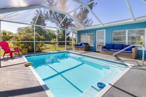 a swimming pool in a house with a conservatory at Relaxing 4 bedroom home with Pool in Punta Gorda