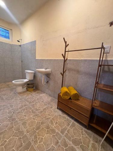 a bathroom with a toilet and a sink at Casa Nawara in Puerto Escondido