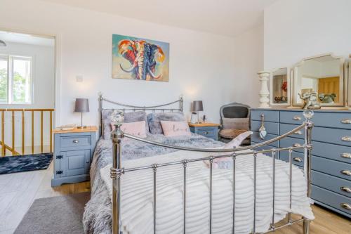 a bedroom with a bed and blue dressers at 3 Bed in Forden oc-c30173 in Forden