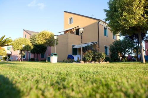 a house with a lawn in front of it at Residence Borgomare in Albenga