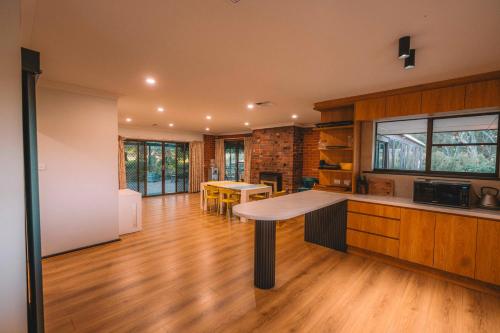 a kitchen with a table in the middle of a room at Vineyard Retreat in the Heart of McLaren Vale in McLaren Vale