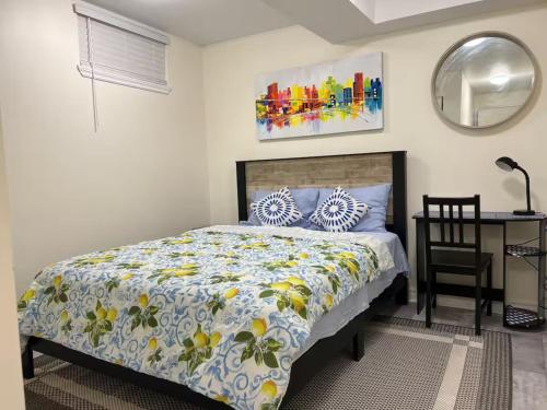 a bedroom with a bed and a table and a mirror at Stylish City Escape in Toronto