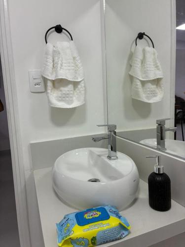 a bathroom with a white sink and a bag of toothpaste at Eco House1 in Santos