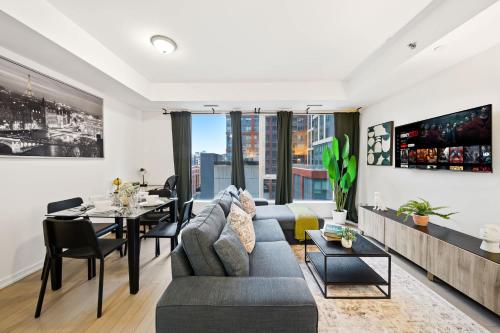 a living room with a couch and a table at Spacious Condo with 2 Beds Unbeatable Location in Toronto