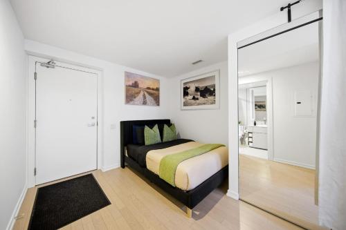 a bedroom with a bed and a large mirror at Spacious Condo with 2 Beds Unbeatable Location in Toronto