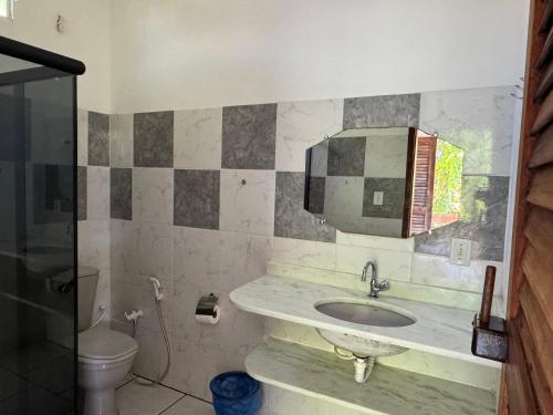 a bathroom with a sink and a toilet at Pousada Vila Verde in Olivença