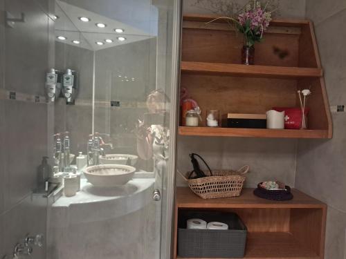 a bathroom with a shower with a sink and a glass shower door at C&MHouse in Buenos Aires