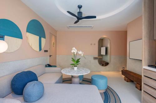 a living room with a couch and a table at Centara Karon Villas Phuket in Karon Beach