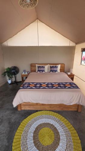 a bedroom with a large bed in a tent at The Breeze Glamping in Bangli