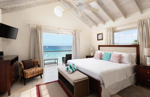 a bedroom with a bed with a view of the ocean at Bianca Bay 3 Bedroom West Coast Beach Front Villa in Saint James