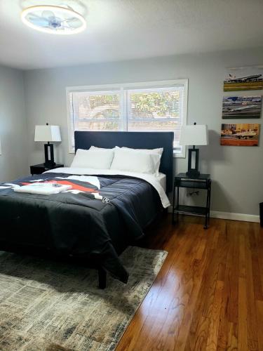 a bedroom with a large bed and two lamps at The Sky Lounge-Brunswick in Brunswick