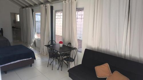a living room with a table and a couch at Casa proximo ao aeroporto in Florianópolis
