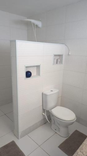 a bathroom with a white toilet in a room at Casa proximo ao aeroporto in Florianópolis