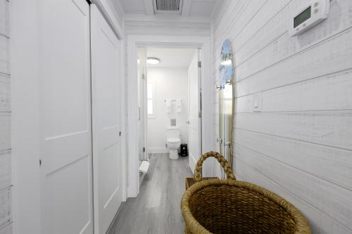 a wicker chair in a hallway with a toilet at Siesta Key Beach Resort and Suites in Sarasota