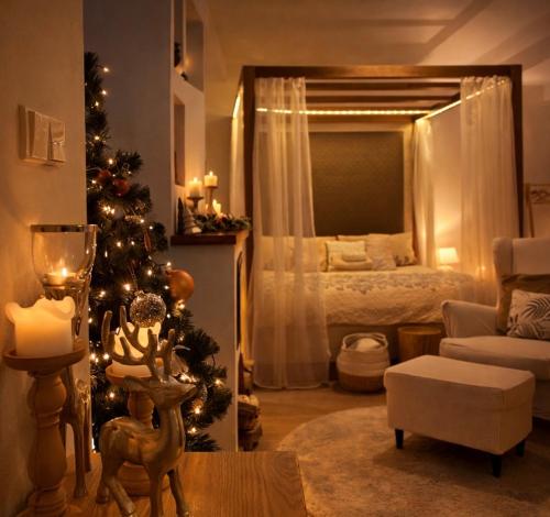 a living room with a christmas tree and a bedroom at Dům u lázní Federer in Třeboň